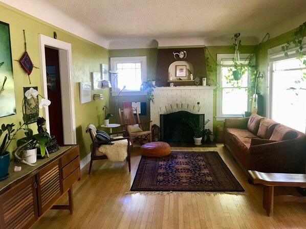 Wood floors, charming second living room, comfortable couch.