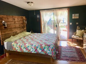 Large king bed w/custom headboards and lighting, sliders to deck and hot tub.
