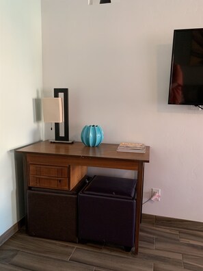 Desk near flat screen tv  in living room.