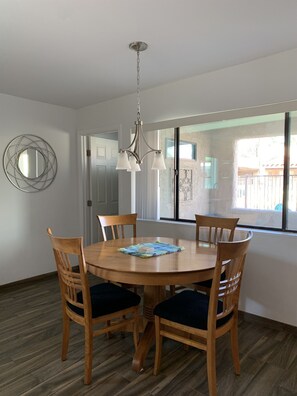 Dining area with view of front porch and pool.