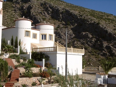 At the edge of a nature reserve, detached villa with pool &  view of sea