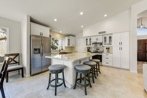 Kitchen adjacent the great room offers a large gathering area