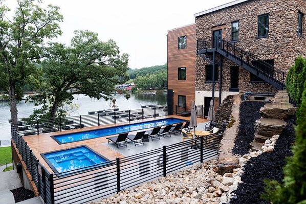 A view from the road of the pool deck over looking the water.