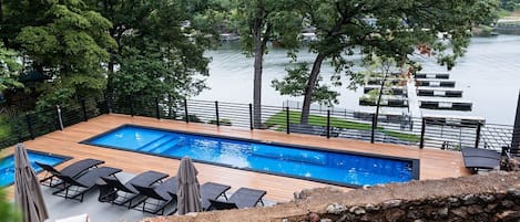 Pool deck with pool/hot tub/grill and outdoor seating that over look the lake