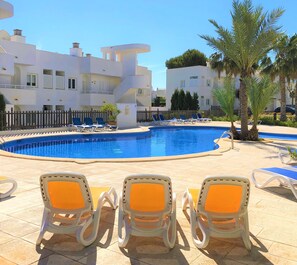 Residential El Puerto I community swimming pool with a large solarium area.