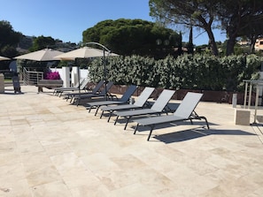 Large sunbathing terrace with sea views & heated swimming pool.