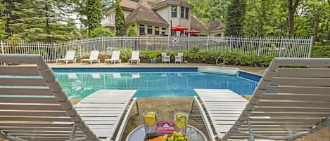 Fenced-in, heated salt-water pool with pool house, shower and plenty of seating!