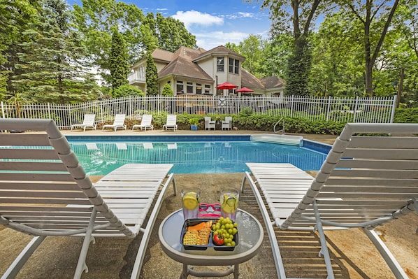 Fenced-in, heated salt-water pool with pool house, shower and plenty of seating!