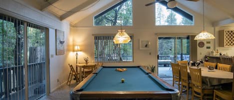 Pool table in the family room, and game table for four.