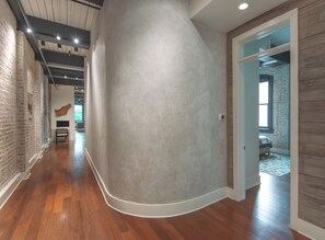 Brick Lined Hallway with Curved Venetian Plaster Walls