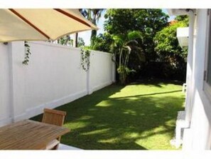 Big private garden with dining table and umbrella