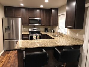 Kitchen with all new Cooking Utensils, Waffle Maker, Coffee Pot, Fresh Fruit!