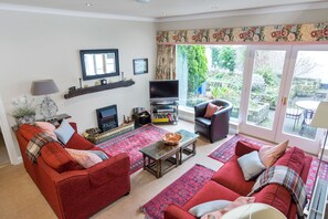 Sitting Room features a large picture window and has direct access to the patio.