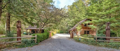 Grand entrance with 2 properties on either side of large driveway