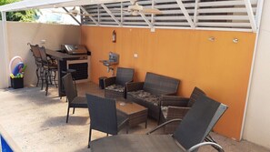 Pool area with seating and gas BBQ grill