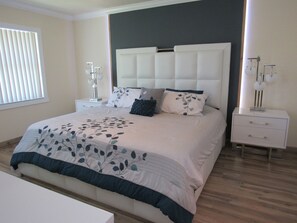 Enjoy a great night sleep on this king size bed in the master bedroom.