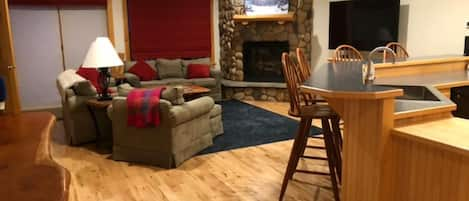 Living room with sliding door to deck for direct trail access, on second floor.