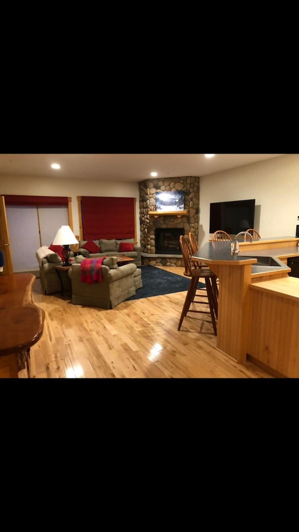 Living room with sliding door to deck for direct trail access, on second floor.