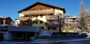 Outside of apartment building showing garage and parking spaces