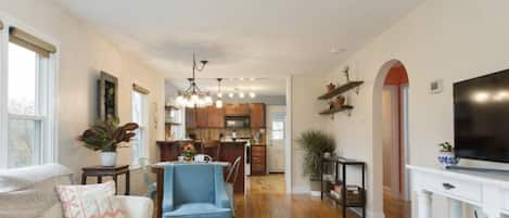 Comfortable living area boasts natural light, plants, and simple design. 