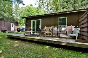 Deck has a large picnic table and additional chairs.