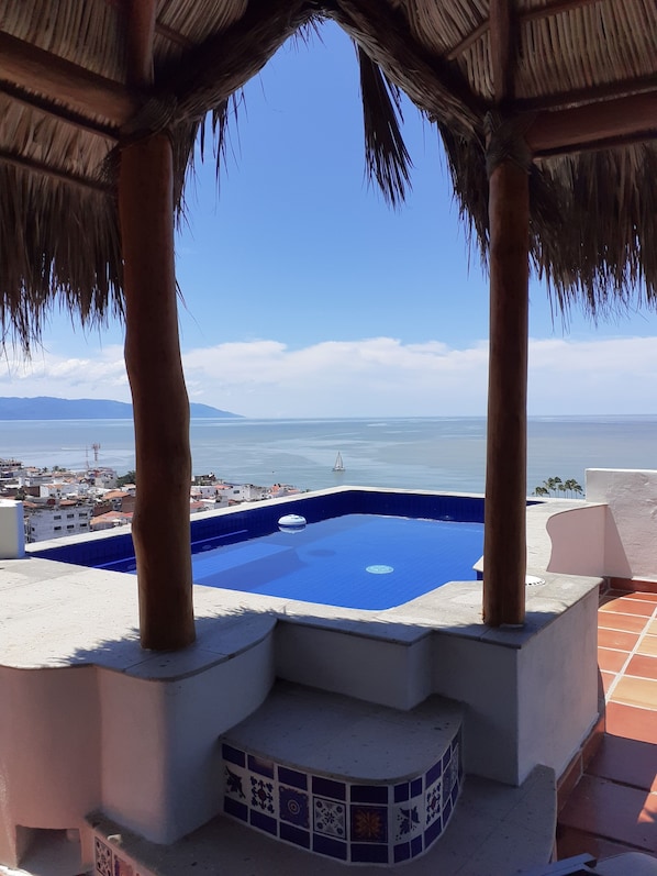 View to the south from private plunge pool, terrace, thatched palapa
