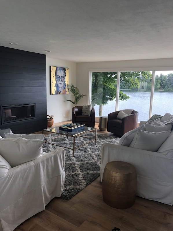 Cozy up in front of the fireplace in the living room overlooking the lake.