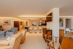 living room with open kitchen and island bar 