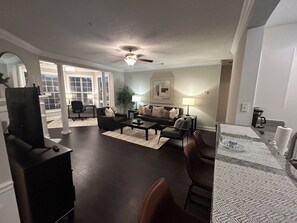Living Rm with Gallery Style Kitchen with Bar Stools