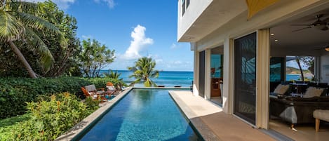 The Caribbean Sea awaits just steps from the pool.