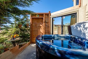 Enjoy a soothing hot tub with a view of the ocean and the stars