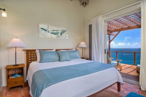 BEDROOM 1:The Primary suite upstairs offers a custom made Balinese teak king bed
