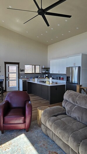 Open floor plan for kitchen, dining, living area with ceiling fan