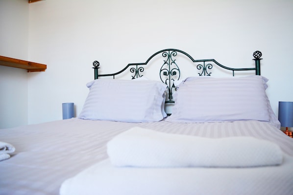 King-sized bed with towels provided