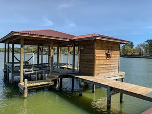 Boathouse with electric lifts for a boat and two jet skis