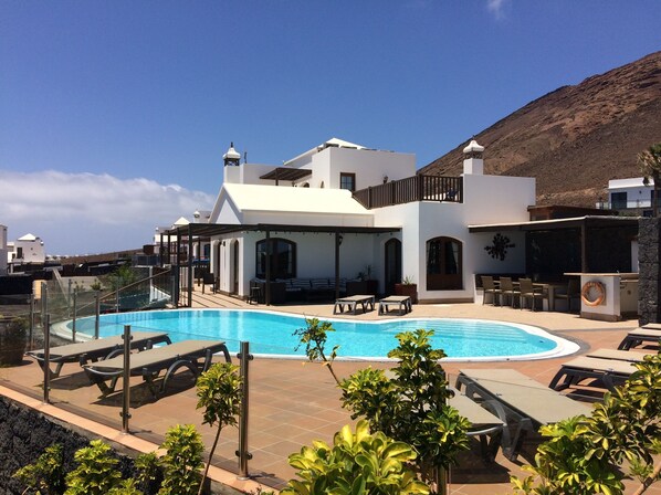 Large kidney shaped pool with plenty of room to sunbathe