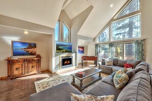 With huge asymmetrical windows and sky lights the natural light in this open-concept living space is stunning
