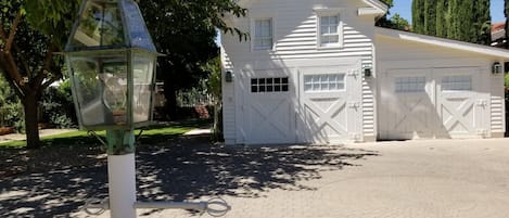 The Cottage on top floor of Carriage House, with parking on paverstones in front