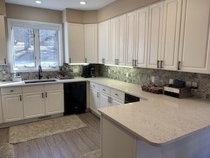 Fully stocked kitchen with Keurig and coffee pot 