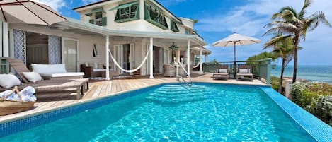 Overlooking the pool with large sun loungers