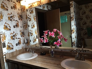 Bathroom with double sinks and shower.