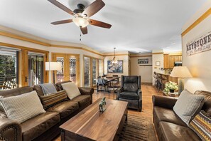 Living area featuring a wood burning fireplace, flat screen TV, and ample seating.