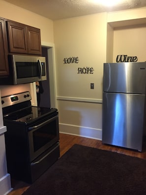 Kitchen with full range, microwave, refrigerator & all the amenities  