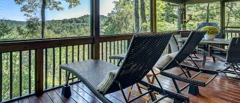 Screened porch featuring dining, lounging and grilling with incredible view