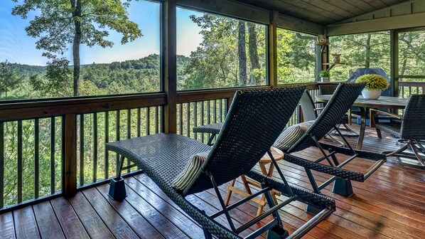 Screened porch featuring dining, lounging and grilling with incredible view