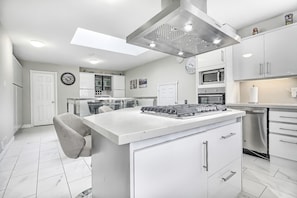 Large kitchen view with entrance door the powder room (bathroom)