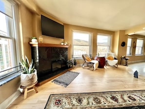 Living room with smart TV and views of the "M" trail on Mount Sentinel.