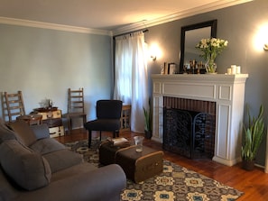 Living room with television, working gas fireplace and a comfy couch to relax.