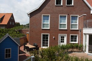 Blick auf die Terrasse, Sonnenschirm und Strandkorb vorhanden