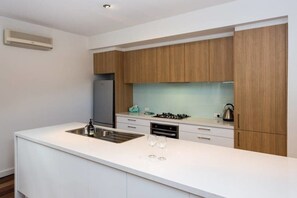 Modern kitchen with plenty of pots, pans and cooking utensils